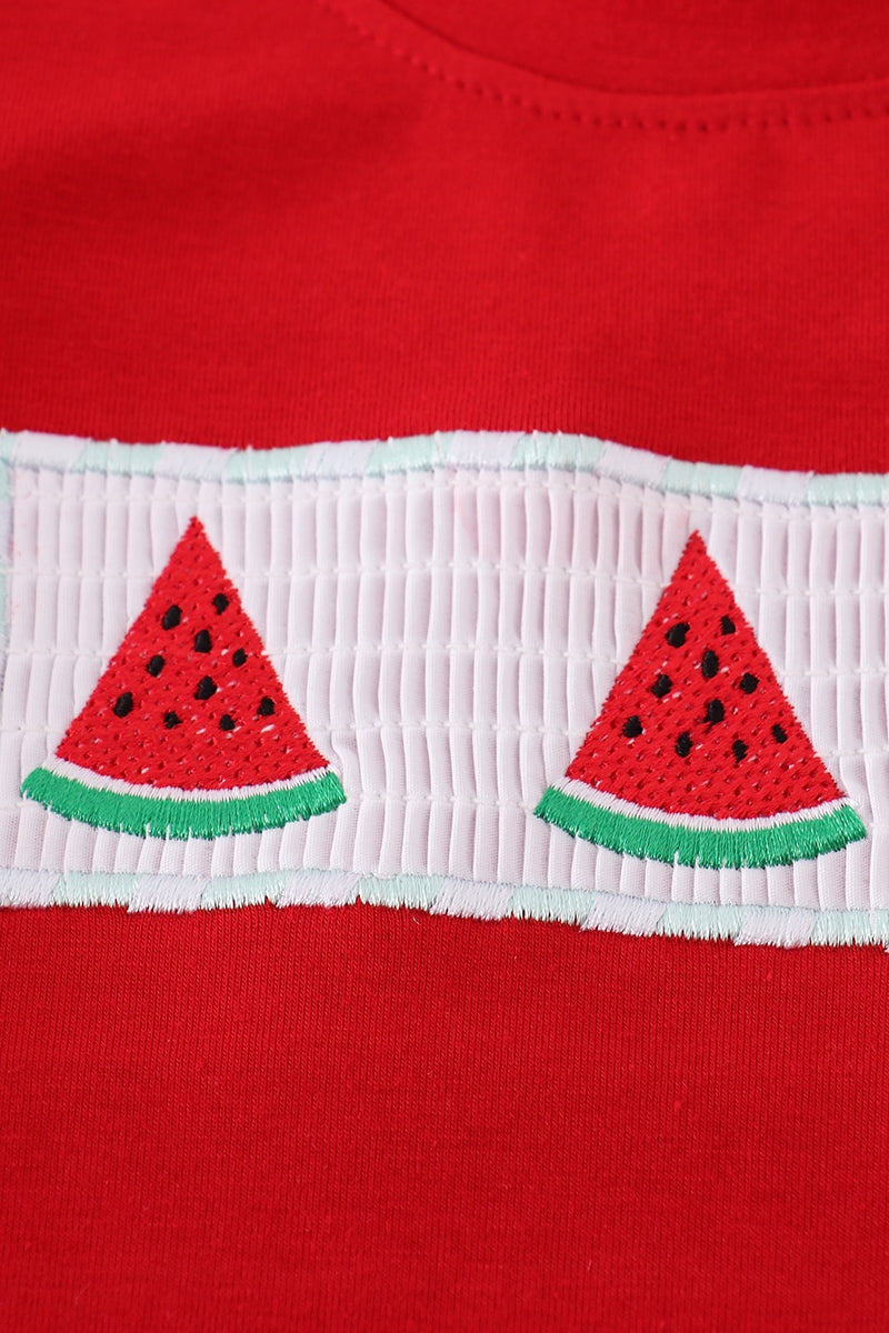 A charming red smocked set with playful watermelon embroidery, perfect for summer fun.