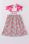 A charming pink dress with playful crab embroidery, perfect for summer fun.