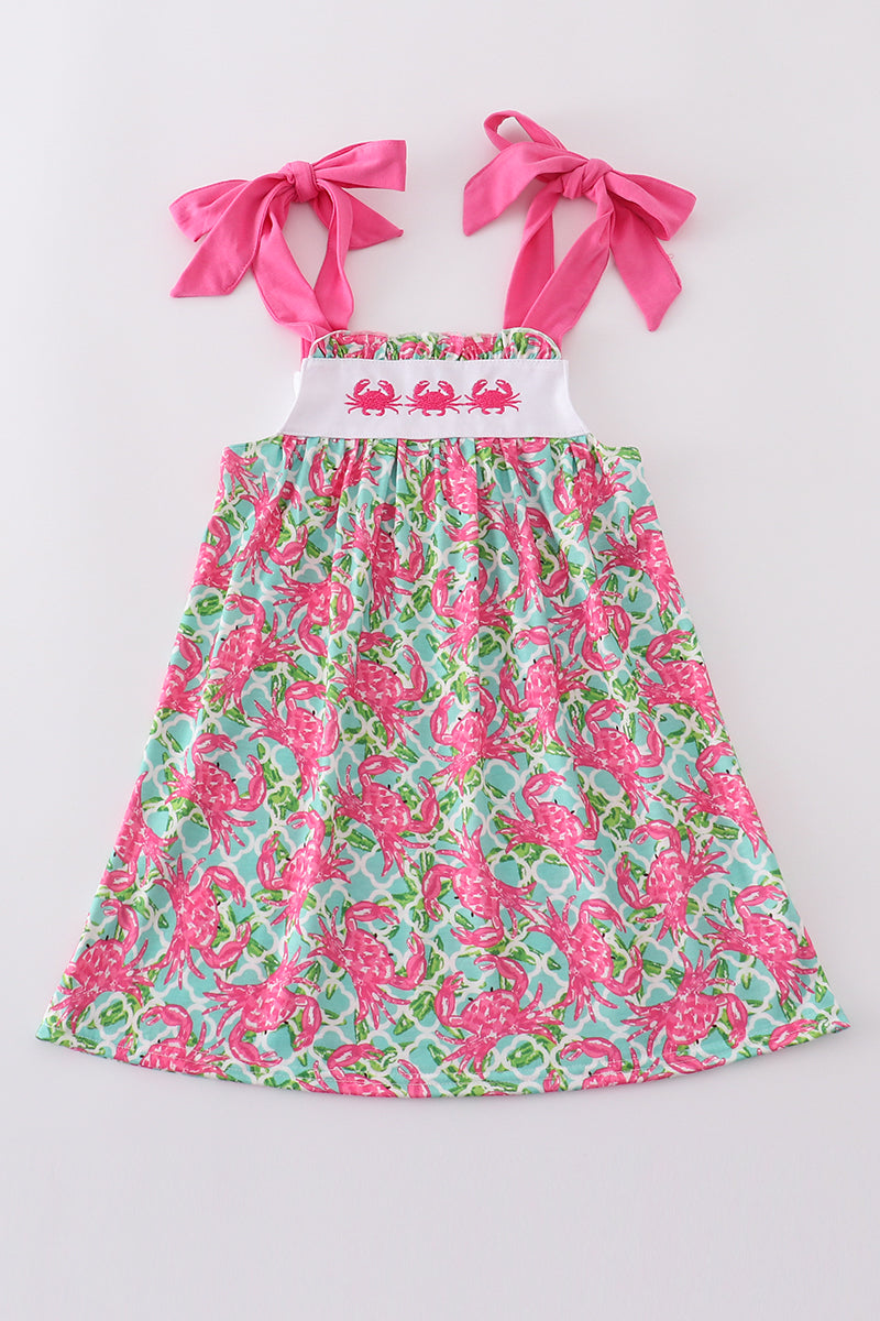 A charming pink dress with playful crab embroidery, perfect for summer fun.