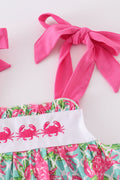 A charming pink dress with playful crab embroidery, perfect for summer fun.