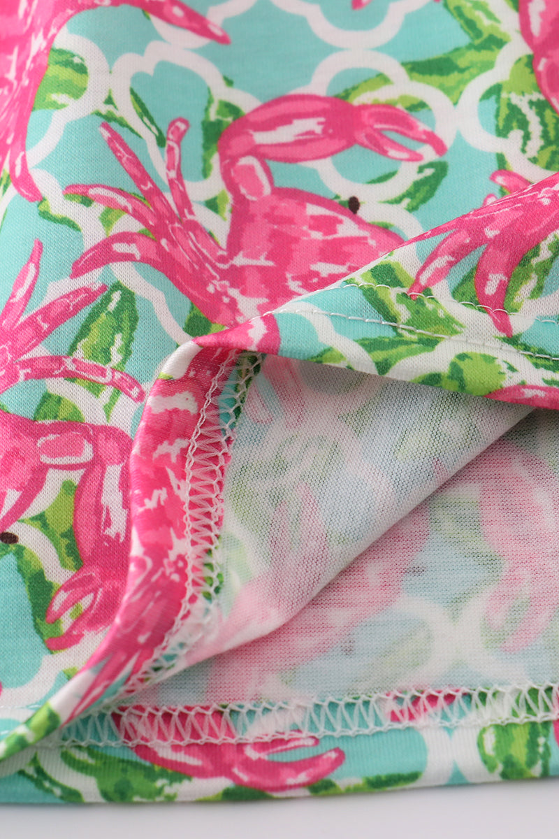 A charming pink dress with playful crab embroidery, perfect for summer fun.