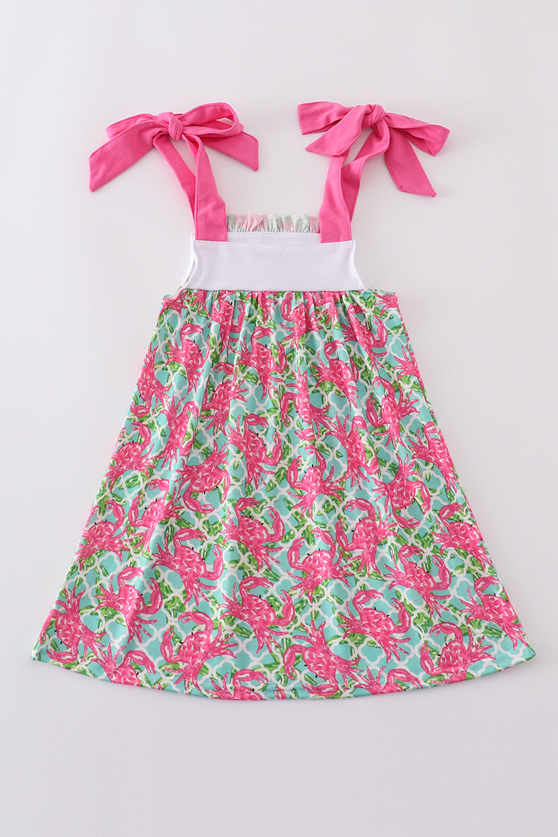 A charming pink dress with playful crab embroidery, perfect for summer fun.