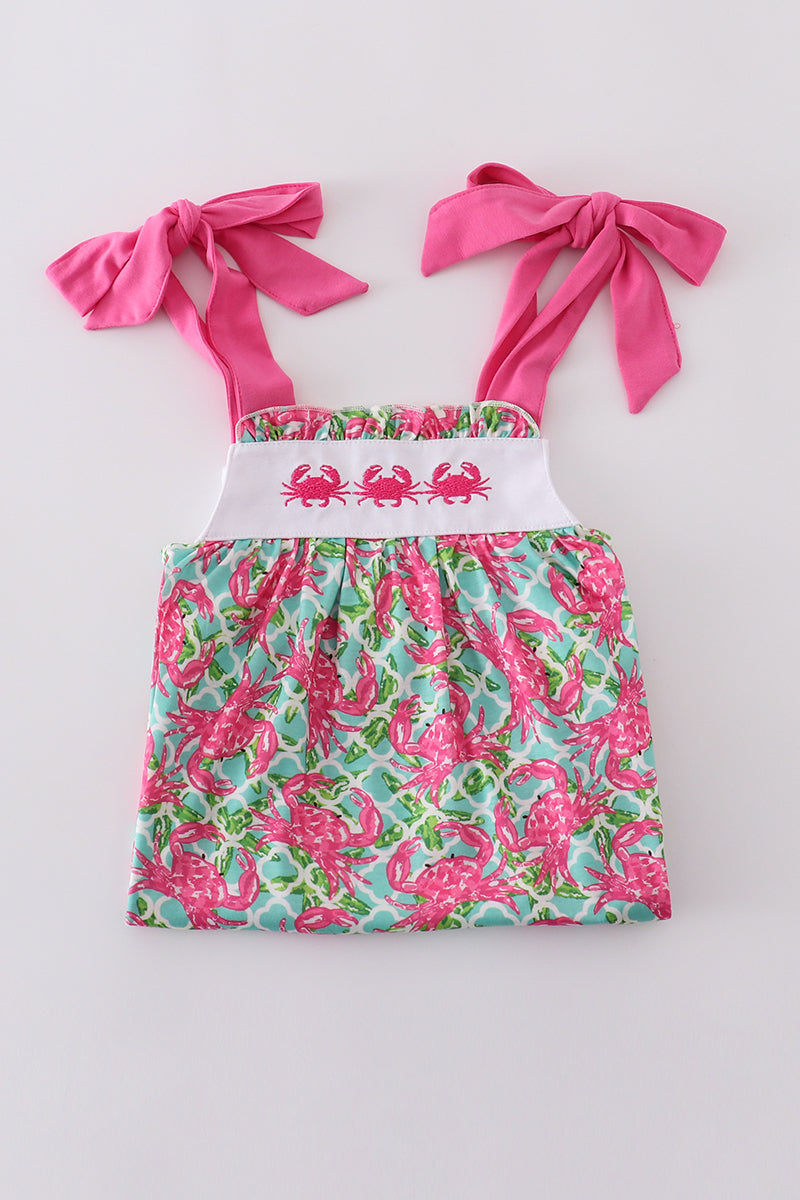A charming pink dress with playful crab embroidery, perfect for summer fun.