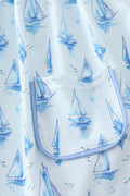 Blue sailboat print girl set featuring a playful nautical design, perfect for summer.