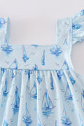 Blue sailboat print girl set featuring a playful nautical design, perfect for summer.