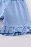 Blue sailboat print girl set featuring a playful nautical design, perfect for summer.