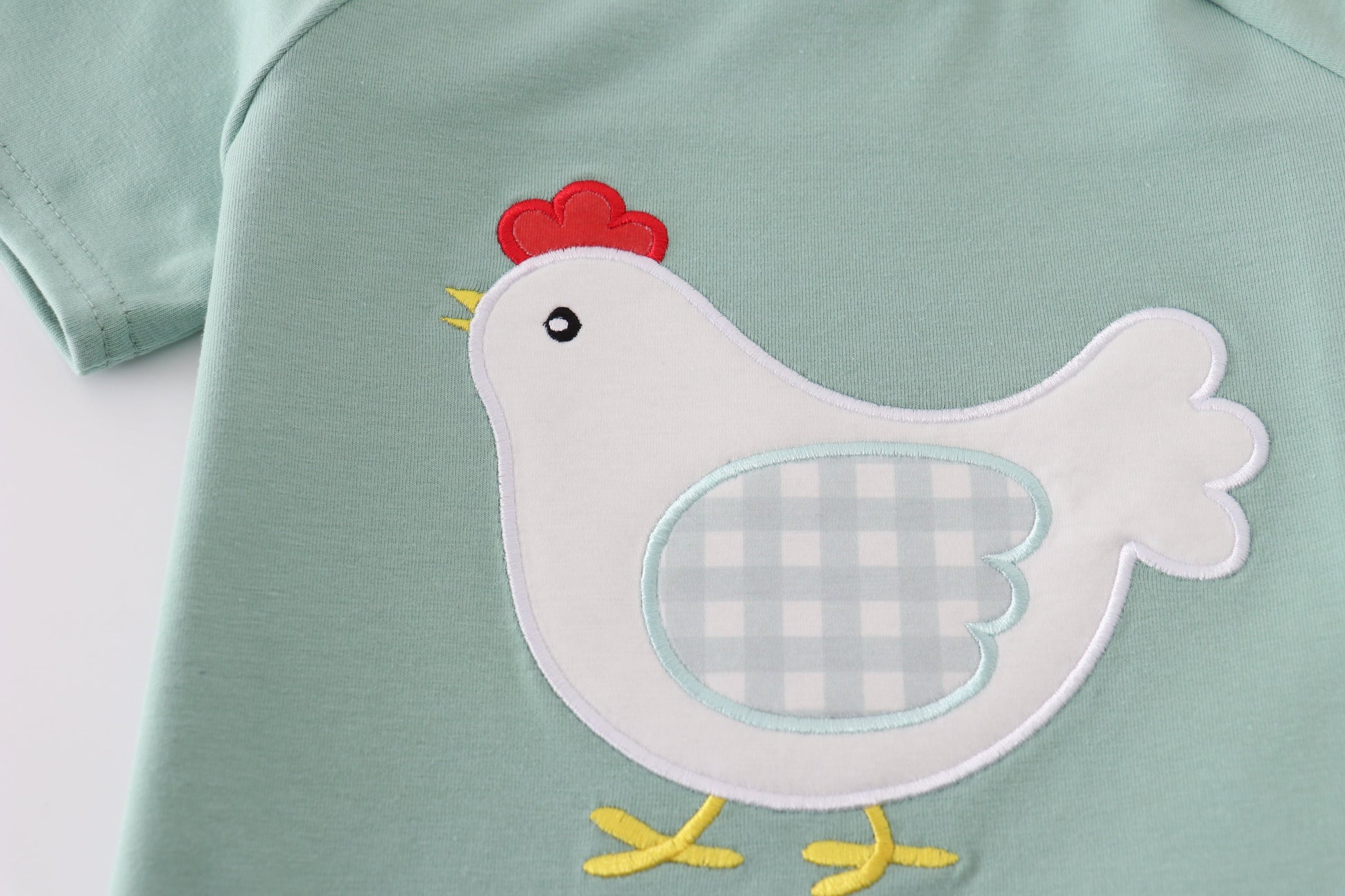 Green boy's outfit with playful chicken applique, perfect for casual playtime.