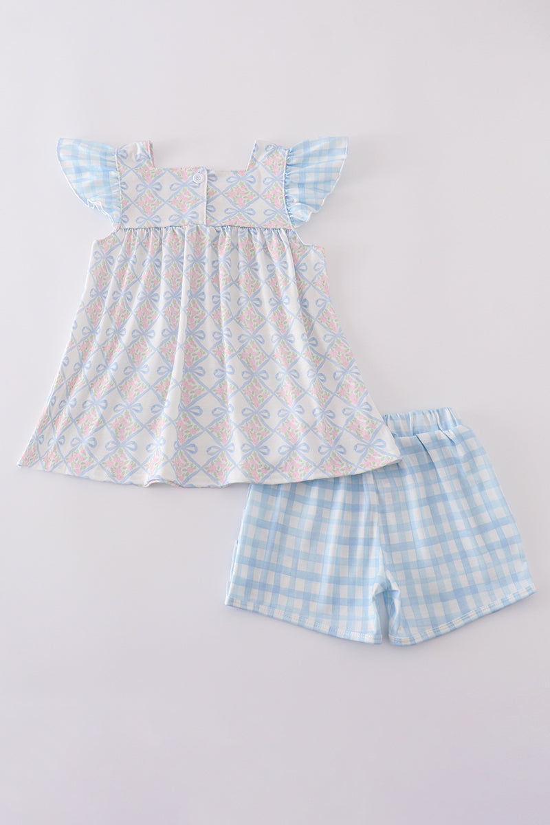 Plaid floral bow print girl set featuring vibrant patterns and playful design.