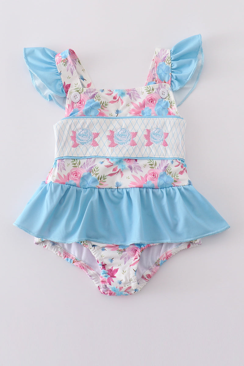 A charming blue one-piece swimsuit with delicate floral embroidery, perfect for summer fun.