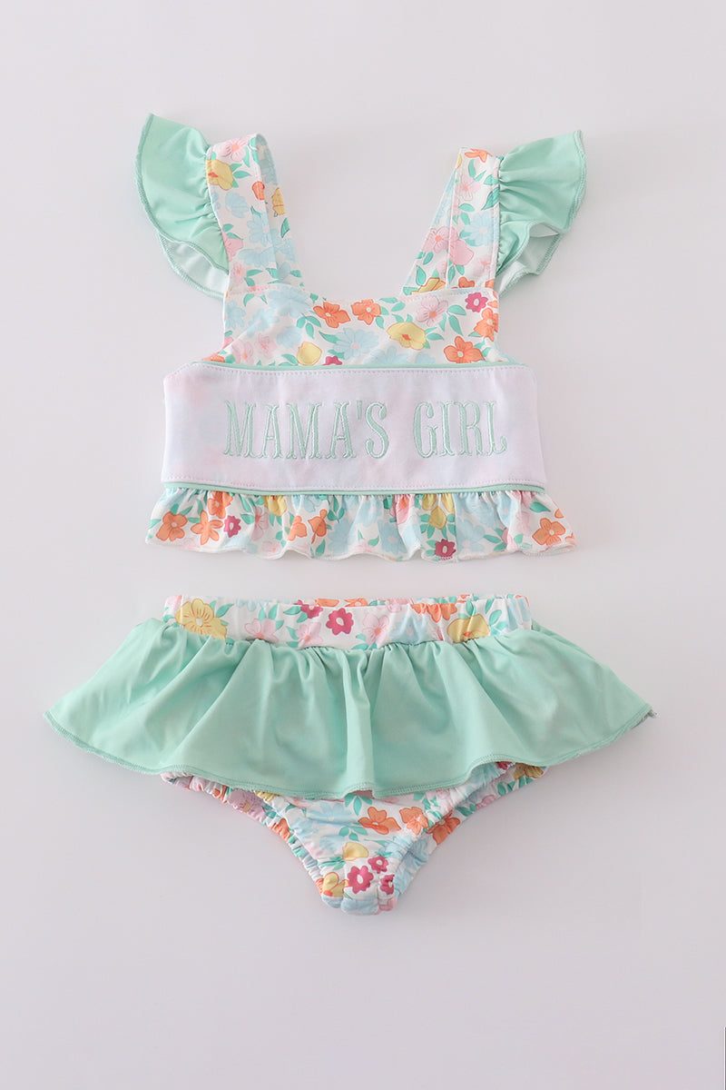 Green two-piece swimsuit with "MAMA'S GIRL" embroidery and floral pattern, perfect for spring.