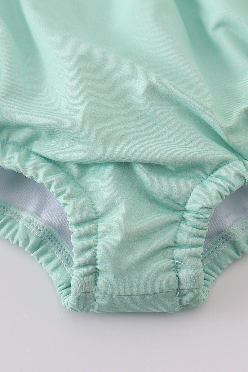 Green floral long sleeve swimsuit for girls, perfect for spring adventures.