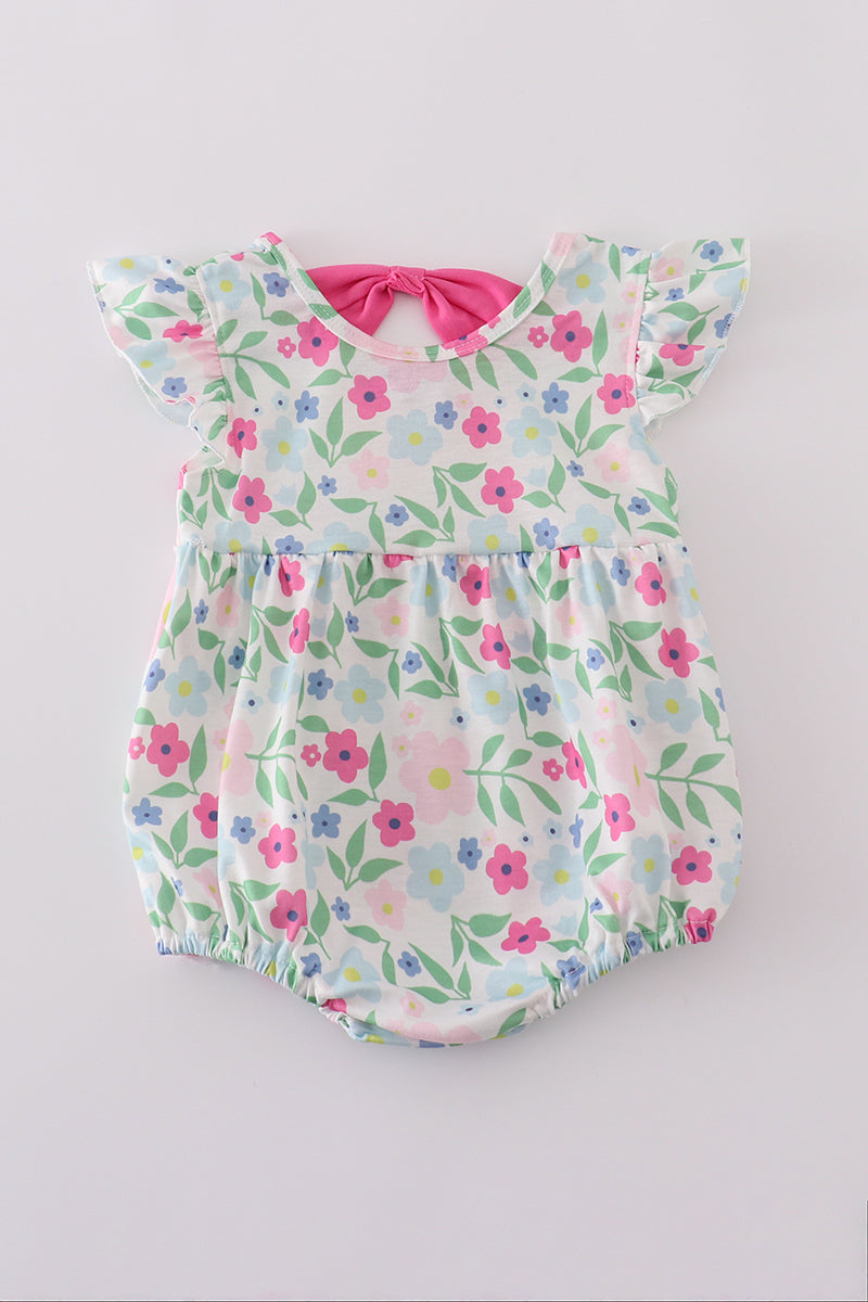 Adorable girl bubble romper with vibrant meadow print, perfect for playful adventures.