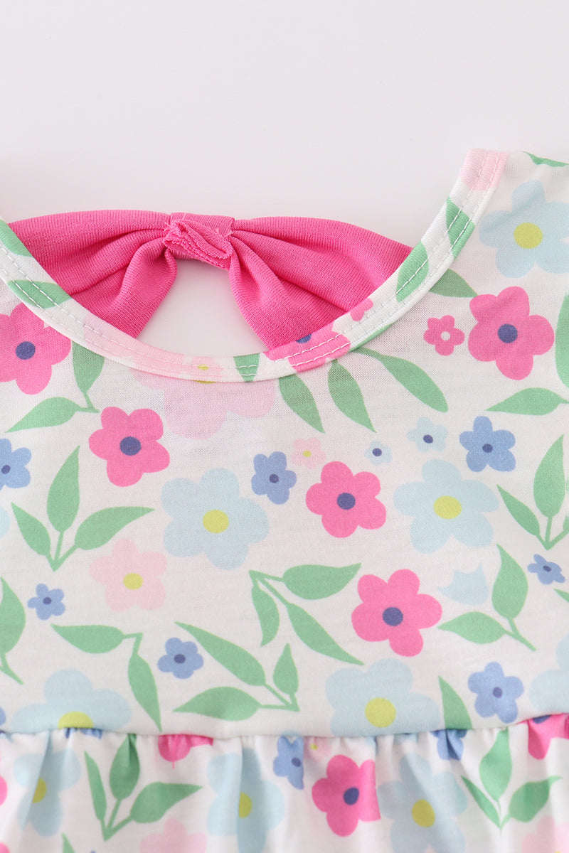 Adorable girl bubble romper with vibrant meadow print, perfect for playful adventures.