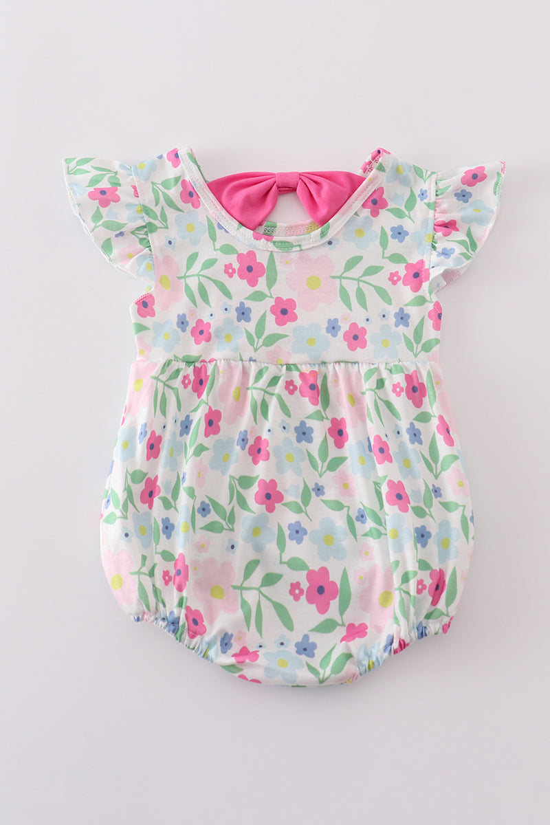 Adorable girl bubble romper with vibrant meadow print, perfect for playful adventures.