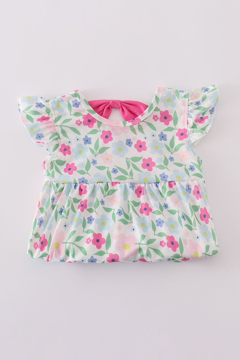 Adorable girl bubble romper with vibrant meadow print, perfect for playful adventures.