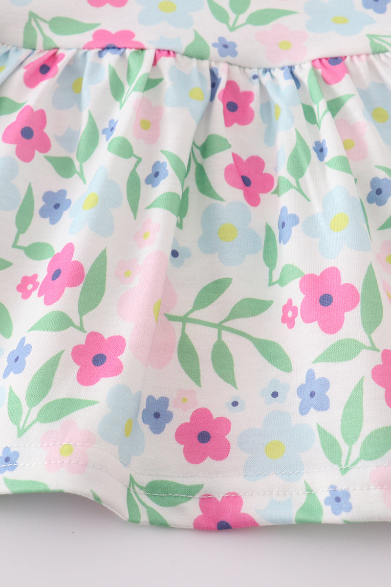 Adorable girl's bloomer set with vibrant meadow print, perfect for sunny days.