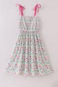 A charming floral-patterned smocked dress with puff sleeves, perfect for spring outings.