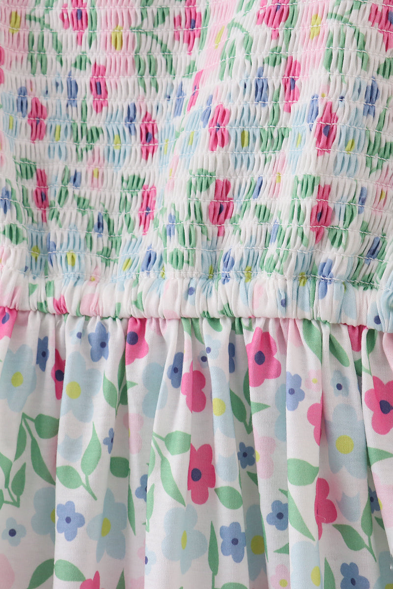 A charming floral-patterned smocked dress with puff sleeves, perfect for spring outings.