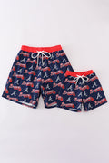 Matching navy swim trunks with Atlanta Braves logo for dad and son.