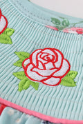 Smocked girl bubble with charming rosebud print, perfect for playful summer days.