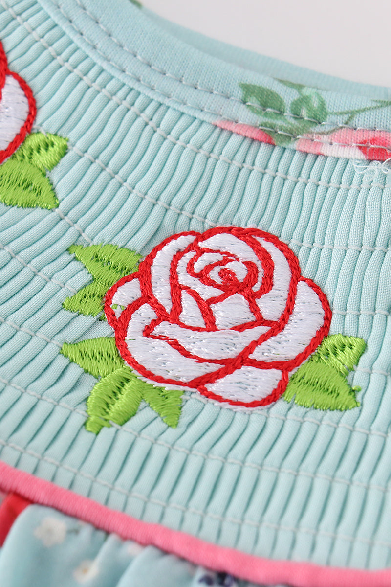 Smocked girl bubble with charming rosebud print, perfect for playful summer days.