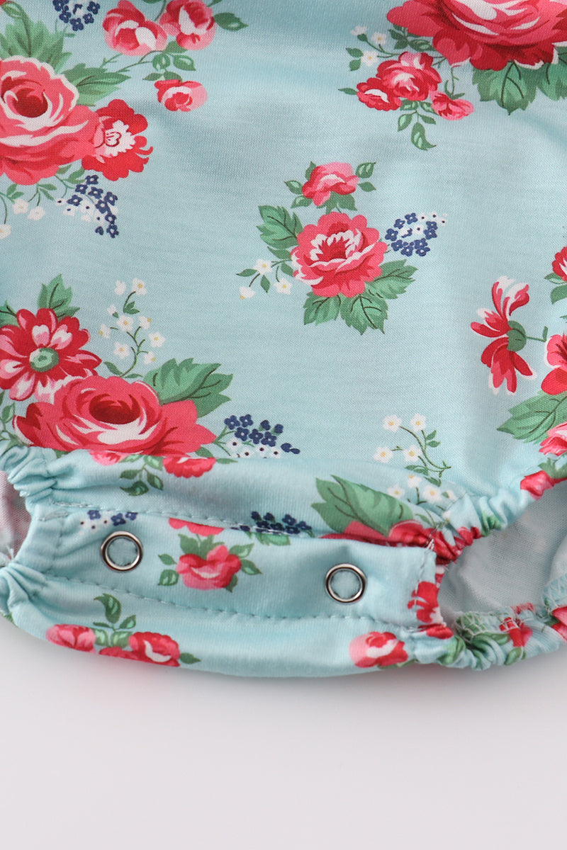 Smocked girl bubble with charming rosebud print, perfect for playful summer days.