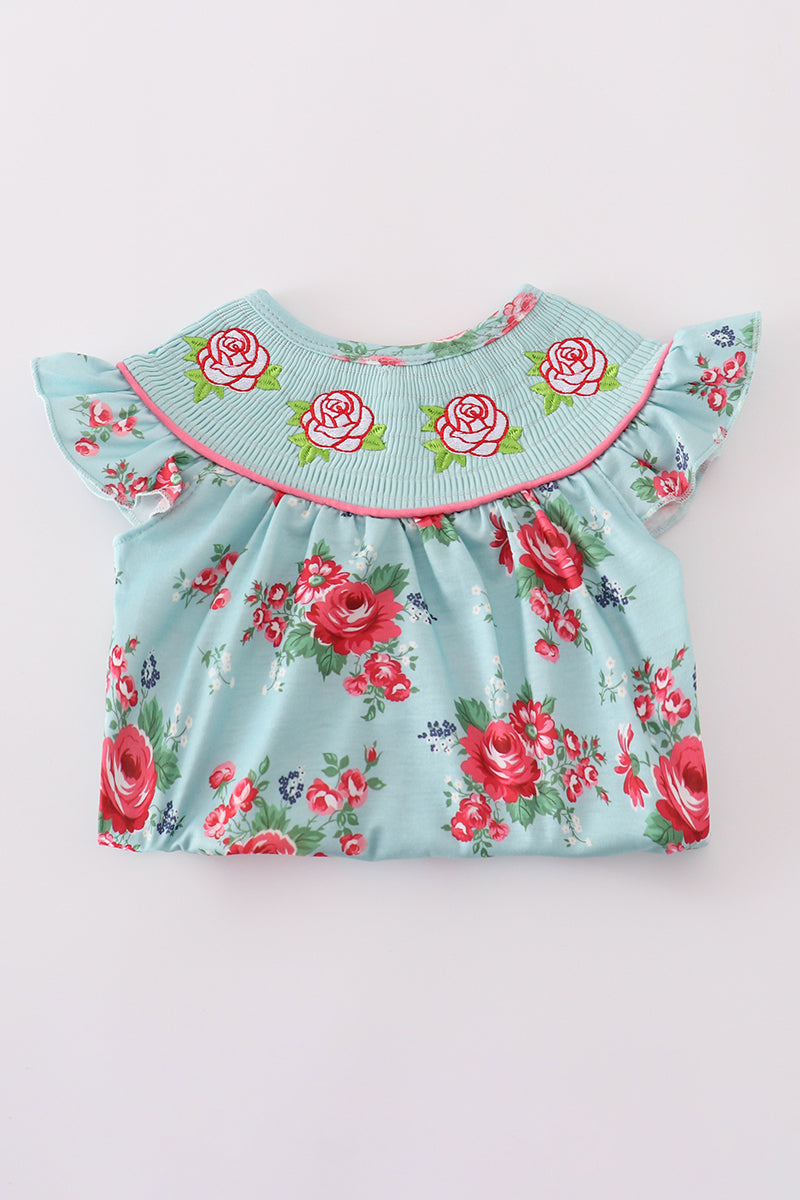 Smocked girl bubble with charming rosebud print, perfect for playful summer days.