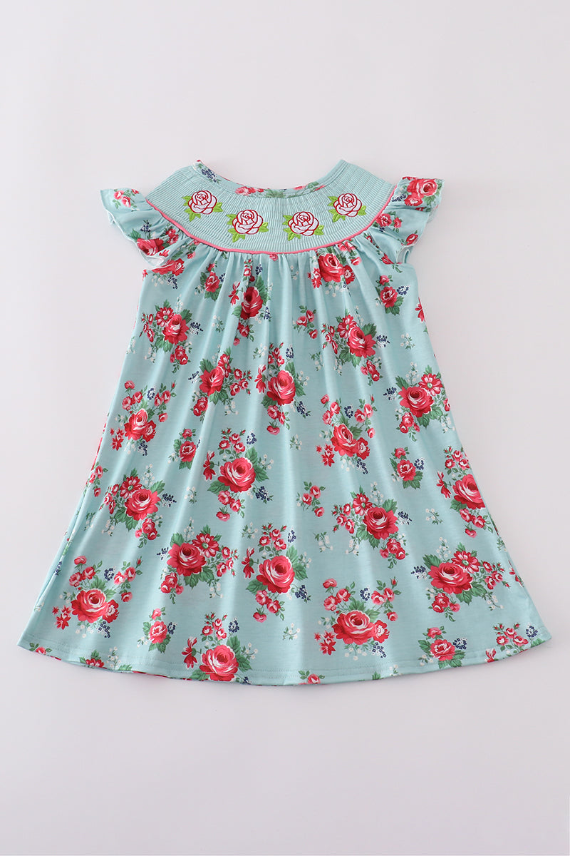 Smocked girl dress with rosebud print, perfect for a spring celebration.