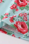 Smocked girl dress with rosebud print, perfect for a spring celebration.