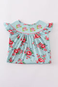 Smocked girl dress with rosebud print, perfect for a spring celebration.