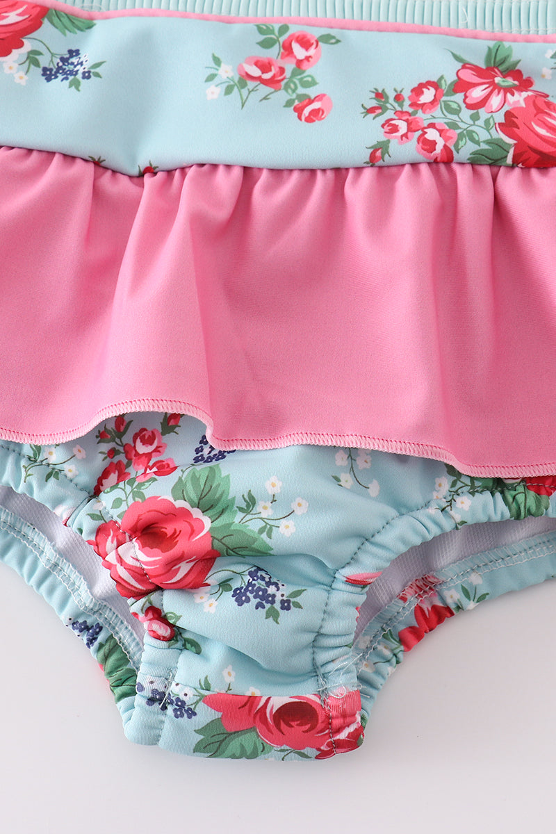 Colorful floral-print one-piece swimsuit with smocked details for girls.