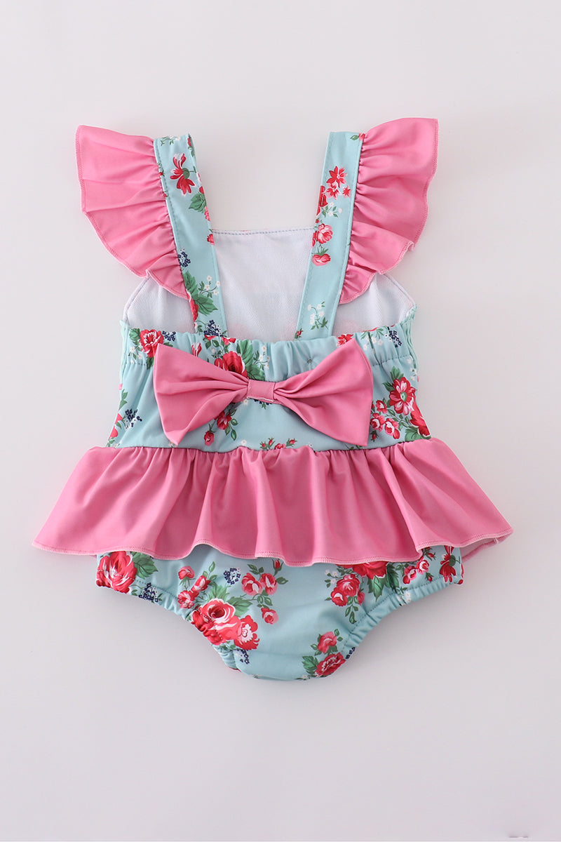 Colorful floral-print one-piece swimsuit with smocked details for girls.