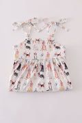 A cute pink dress with playful puppy prints, perfect for parties.