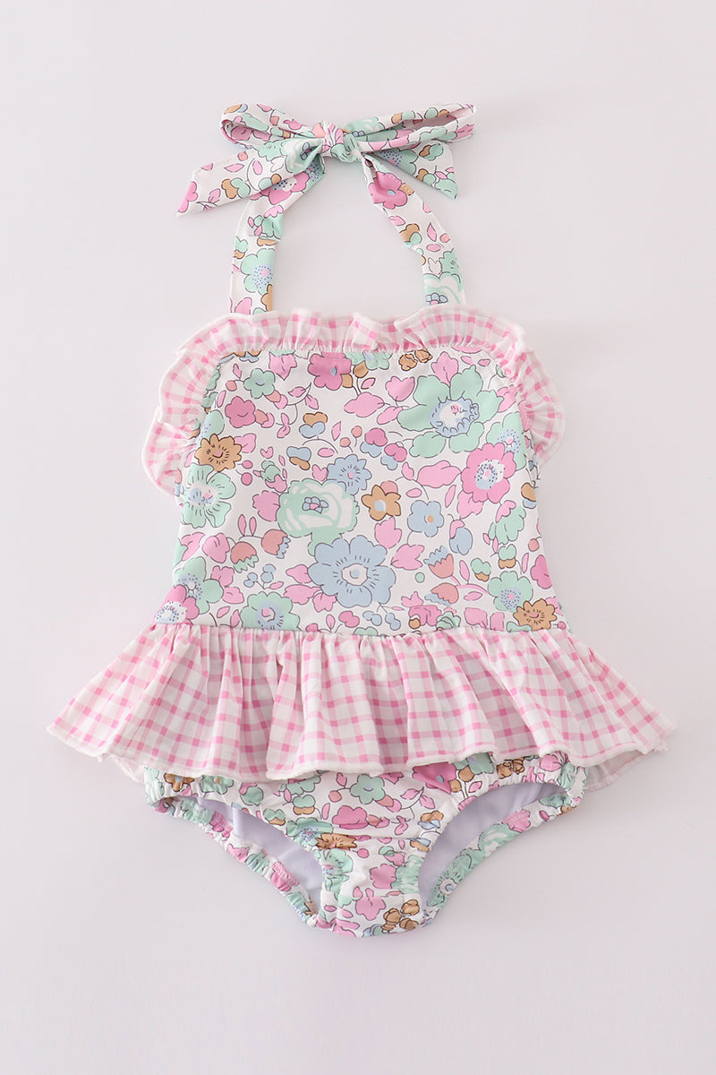 Pink floral one-piece swimsuit for kids, featuring cheerful flower patterns.