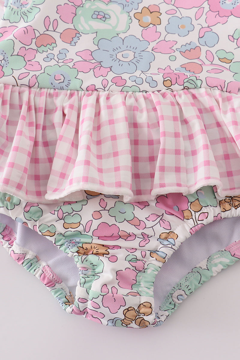 Pink floral one-piece swimsuit for kids, featuring cheerful flower patterns.