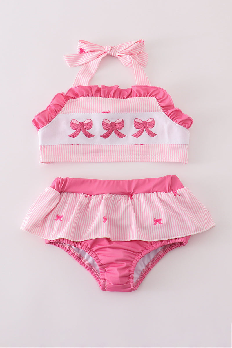 Pink stripe swimsuit with bow embroidery, perfect for a sunny beach day.