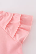 Pink summer floral print ruffle dress with playful flowers and soft, flowing fabric.