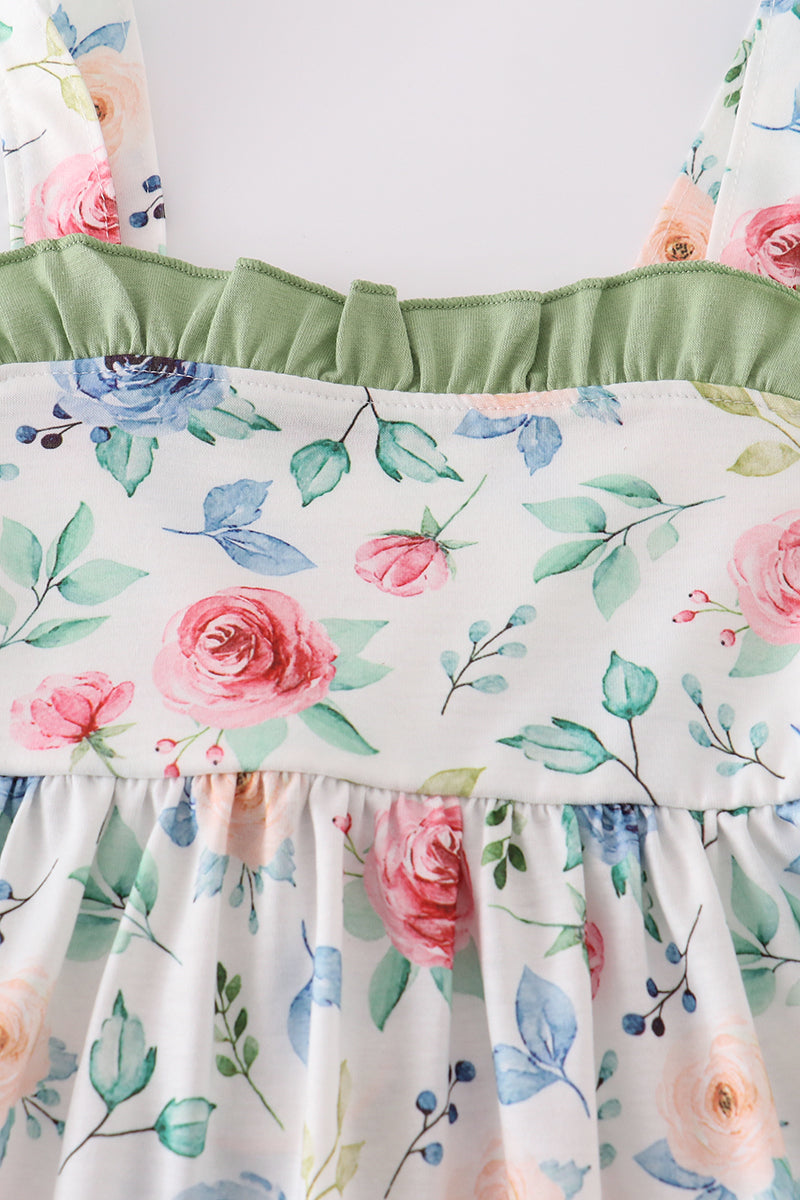 Green garden rose dress with vibrant floral pattern, perfect for playful summer days.