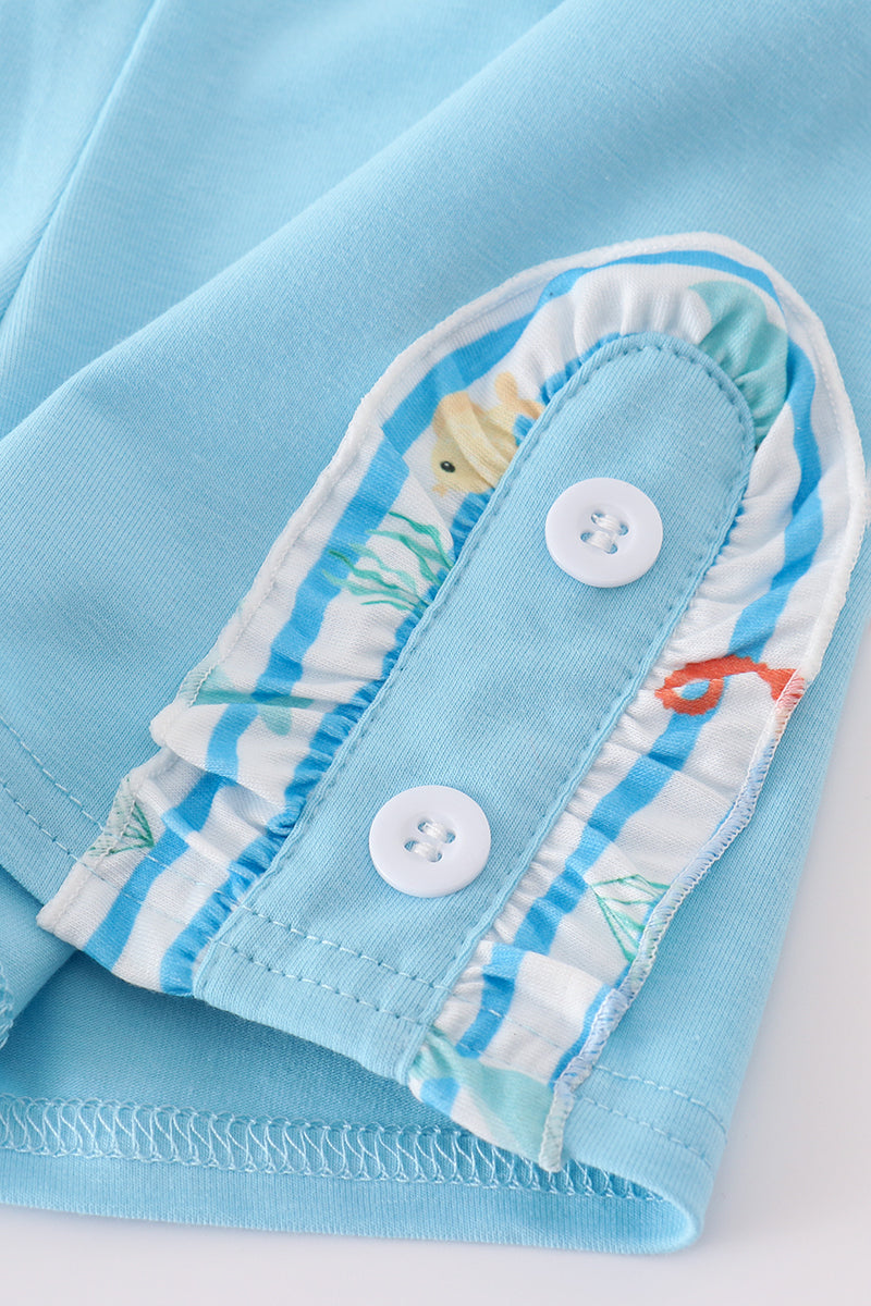 Children’s blue outfit with embroidered sea creatures, perfect for playtime adventures.