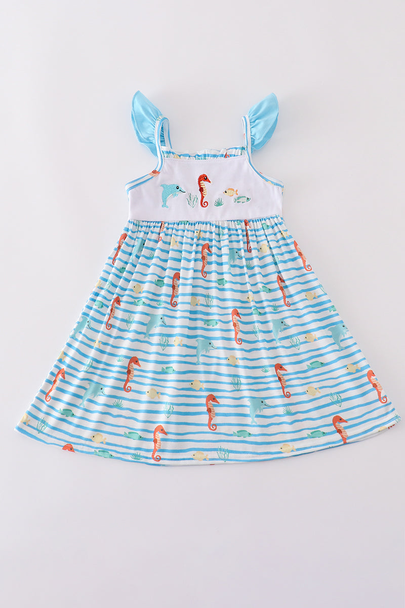 Blue dress with playful marine creature embroidery, perfect for seaside adventures.