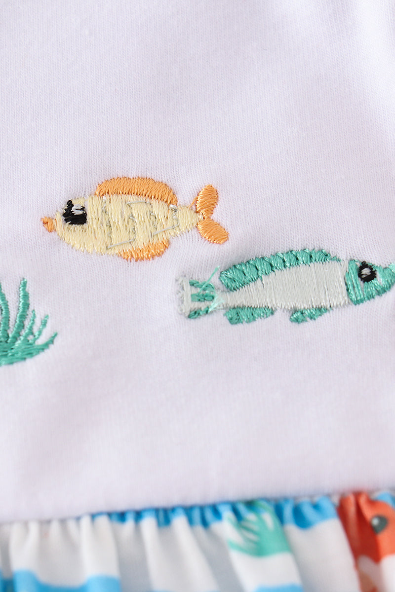 Blue dress with playful marine creature embroidery, perfect for seaside adventures.