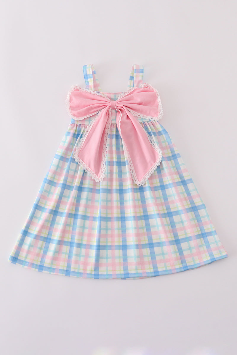 A charming pink plaid bow dress, perfect for playful adventures and special occasions.