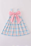 A charming pink plaid bow dress, perfect for playful adventures and special occasions.