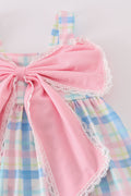 A charming pink plaid bow dress, perfect for playful adventures and special occasions.