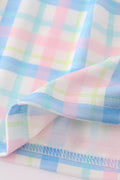 A charming pink plaid bow dress, perfect for playful adventures and special occasions.