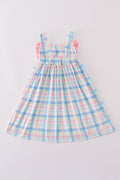 A charming pink plaid bow dress, perfect for playful adventures and special occasions.