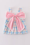 A charming pink plaid bow dress, perfect for playful adventures and special occasions.
