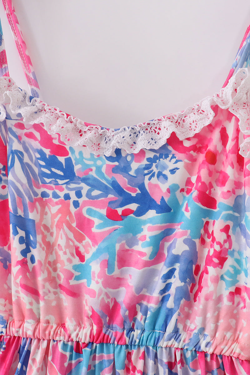 Mom wearing a vibrant tiered dress with tropical sunset wave patterns, perfect for summer.