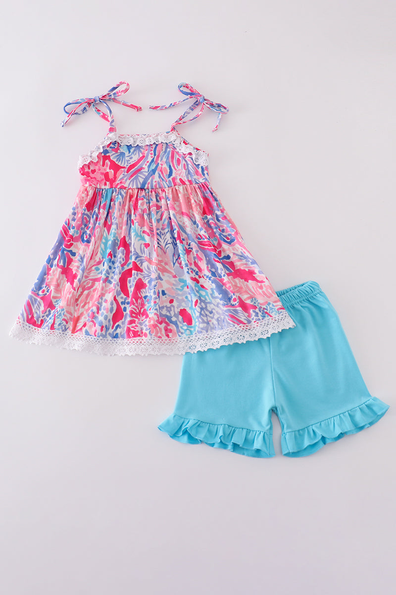 Tropical Sunset Waves set: vibrant beach-themed shirt and shorts with colorful wave patterns.