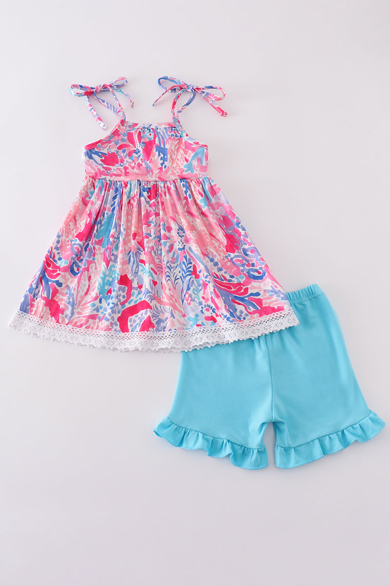 Tropical Sunset Waves set: vibrant beach-themed shirt and shorts with colorful wave patterns.